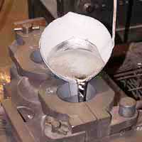 Pouring molten zinc into a zinc anode mold